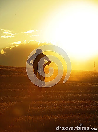 Silhouette sport man cycling downhill riding cross country mount Stock Photo