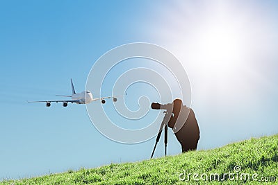 Silhouette of spotter photographer capturing photos of landing airliner Stock Photo