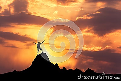 Silhouette of a standing happy man on the mountain peak Stock Photo