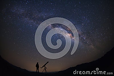 Silhouette of a standing man with telescope watching the wilky w Stock Photo