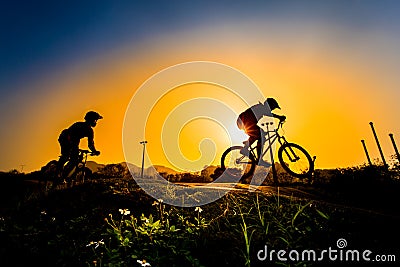 Silhouette Of Stunt Bmx Riders Stock Photo