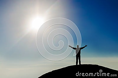 Silhouette of successful man on the mountain peak Stock Photo