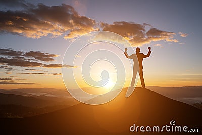 Silhouette successful man on the top of the hill and the sunset Stock Photo