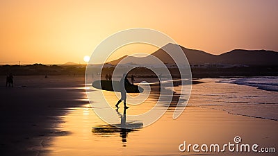 Silhouette of a Surfer on Famara beach at sunset Editorial Stock Photo