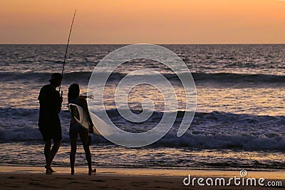 A Surfer Girl and Fisherman at Sunset. Editorial Stock Photo