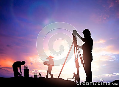 Silhouette survey engineer working in a building site over Blur Stock Photo