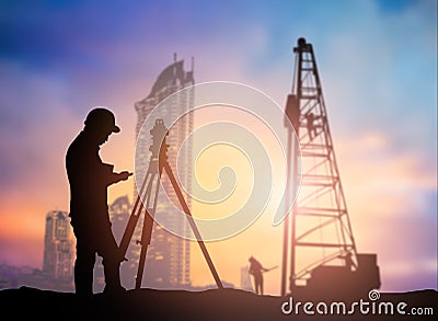 silhouette survey engineer working in a building site over Blurred construction worker on construction site Stock Photo