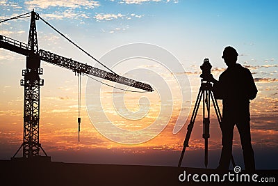 Surveyor Standing With Equipment At Construction Site Stock Photo