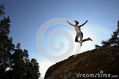 Silhouette Of Teenage Girl Leaping In Air Stock Photo
