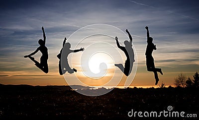 Teenagers jumping in sunset for fun Stock Photo