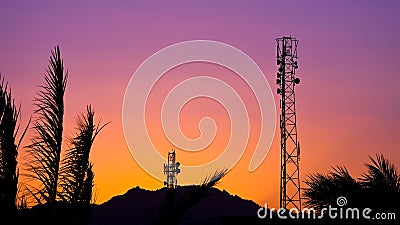 Silhouette of telecommunication antenna cellular tower for telephony with beautiful sunset Stock Photo