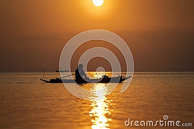 Silhouette of thai man in a boat during sunset at sea water near tropical island Koh Phangan, Thailand Editorial Stock Photo