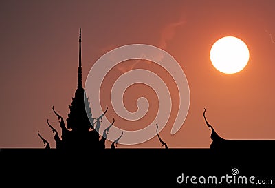 Silhouette of Thai Temple with Dramatic sunset sky. Stock Photo