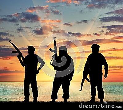 Silhouette of three terrorists Stock Photo