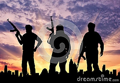 Silhouette of three terrorists Stock Photo