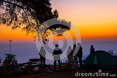 Silhouette tourist group standing on the top of mountain looking to sunrise Editorial Stock Photo