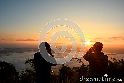 Silhouette Tourist takes photos beautiful landscape mountain Stock Photo