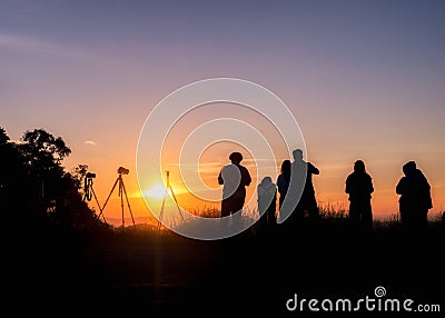 Silhouette tourists stand looking view at sunset Stock Photo