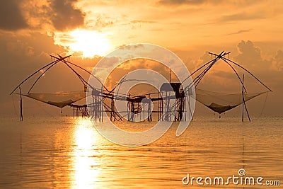 Silhouette traditional horse asia fishing net on sunrise. Stock Photo