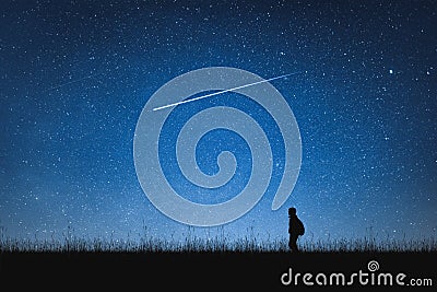 Silhouette of traveler standing on mountain and night sky with stars. Space background. Stock Photo