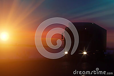 Silhouette Truck with container on highway, cargo transportation concept. Sunset background with copy space Stock Photo