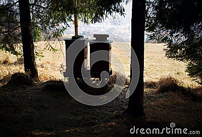 Silhouette two beehives at the edge of the forest Stock Photo