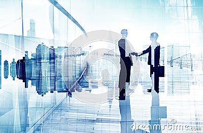 Silhouette of Two Business People Having a Handshake Stock Photo