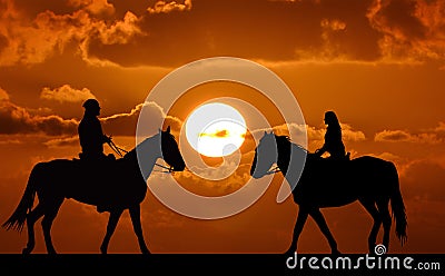 Silhouette of two riders on sunset Stock Photo