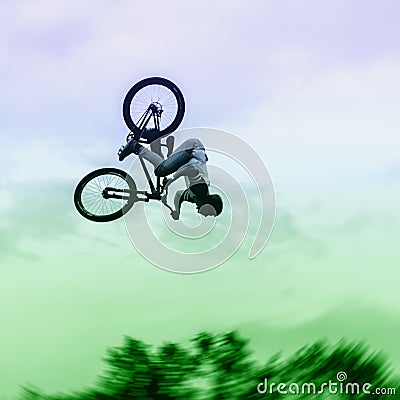 Silhouette of unidentified young man performs stunts on background of vivid sky. Extrem Sport and risk Stock Photo