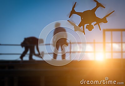 Silhouette of Unmanned Aircraft System UAV Quadcopter Drone In Stock Photo