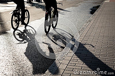 Silhouette of unrecognised people cycling outdoor in the morning. People exercising. Healthy lifestyle outdoor Stock Photo