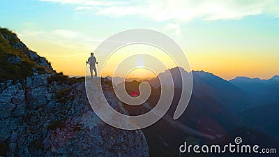 SILHOUETTE: Unrecognizable male tourist hiking in the Alps observing the sunset. Stock Photo