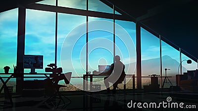 The silhouette of a videographer at a workplace in his office. Stock Photo