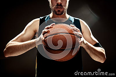 Silhouette view of a basketball player holding basket ball on black background Stock Photo