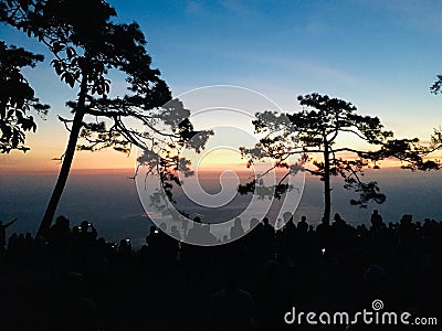 Silhouette view of crowd and colorful sky at peak mountain Stock Photo