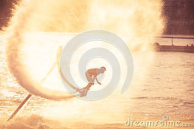 Silhouette and vintage color styl showing flyboard on Chaophya r Stock Photo