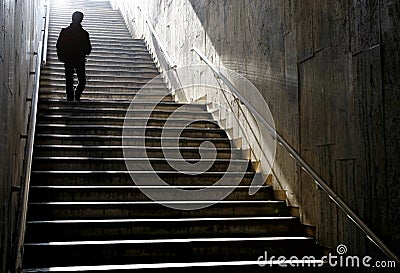Silhouette walking down the stairs Stock Photo