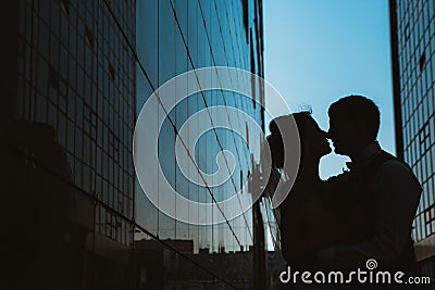 Silhouette Wedding couple on background mirror buildings Stock Photo