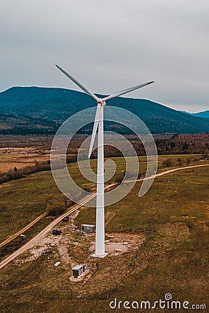 Silhouette of a wind turbine on a mountain at sunset, a windmill in the Ukrainian Carpathians, a windmill close up, top view Stock Photo