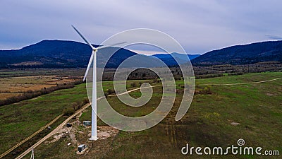 Silhouette of a wind turbine on a mountain at sunset, a windmill in the Ukrainian Carpathians, a windmill close up, top view Stock Photo