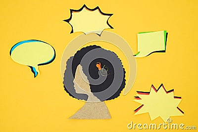 Silhouette of woman with afro hair and several empty comic balloons, cut out on paper on cream background. Copy space Stock Photo