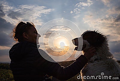 silhouette of woman and dog head at sunset pet teraphy Stock Photo