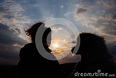 silhouette of woman and dog head at sunset pet teraphy Stock Photo