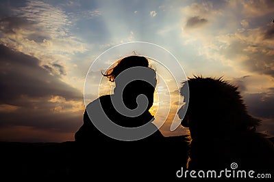 silhouette of woman and dog head at sunset pet teraphy Stock Photo