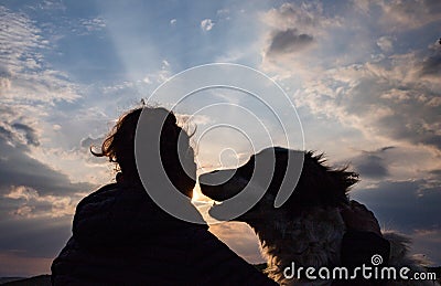 silhouette of woman and dog head at sunset pet teraphy Stock Photo