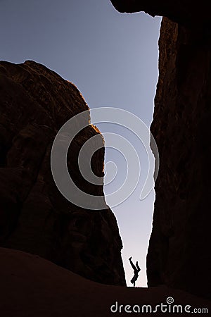 Woman doing a cart wheel in a narrow canyon Stock Photo