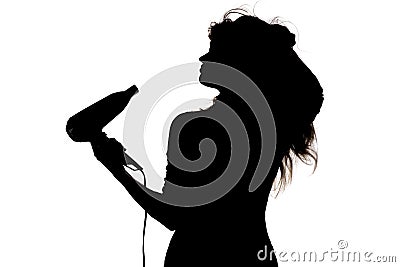 Silhouette of a woman doing a hairstyle with hair dryer, concept of fashion and beauty Stock Photo