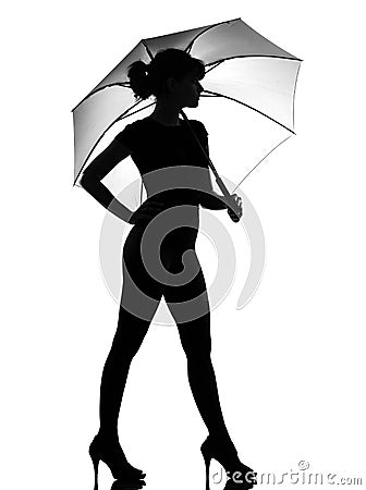 Silhouette woman holding open umbrella Stock Photo