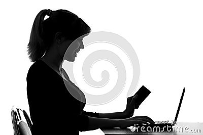 Silhouette of a woman makes online purchase at home Stock Photo