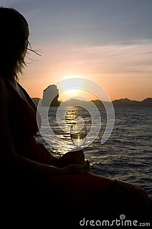 Silhouette of a woman and ocean sunset Stock Photo